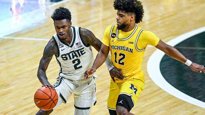 MSU's Rocket Watts dribbles against Michigan's Mike Smith